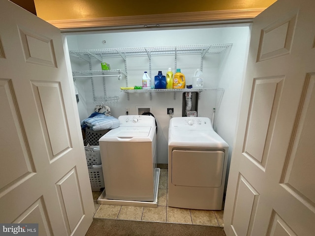 laundry area featuring light tile patterned flooring and washing machine and dryer