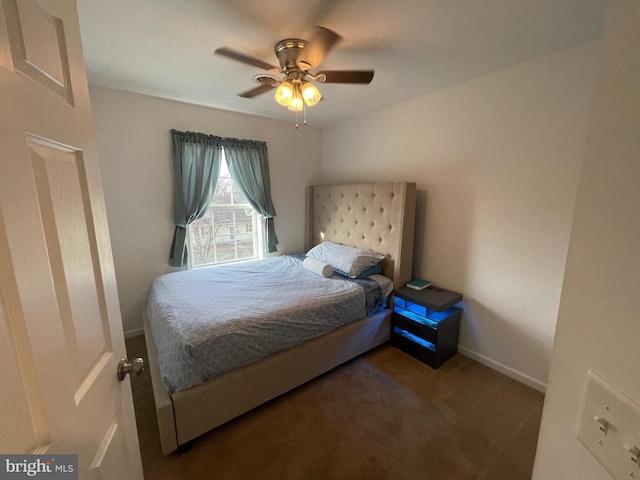 bedroom with ceiling fan and dark carpet