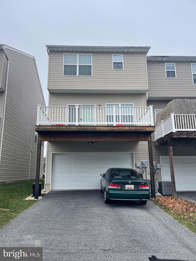 view of front of home with a balcony and a garage