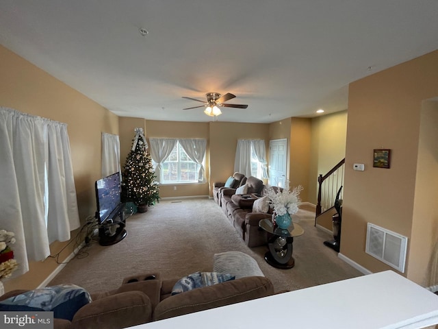 carpeted living room featuring ceiling fan