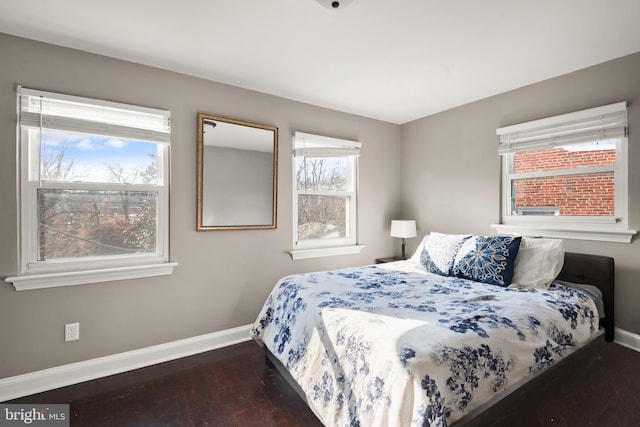 bedroom with dark hardwood / wood-style flooring