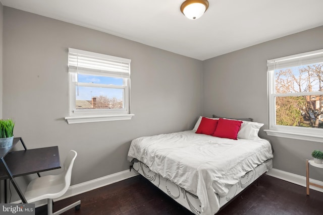 bedroom with dark hardwood / wood-style flooring