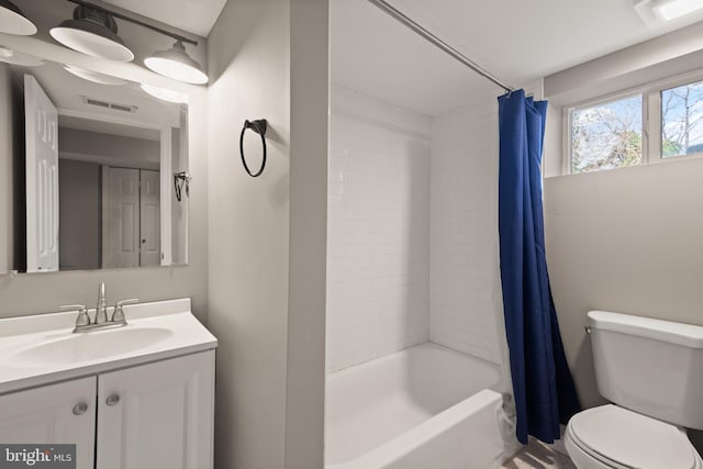 full bathroom featuring shower / bath combo, toilet, and vanity