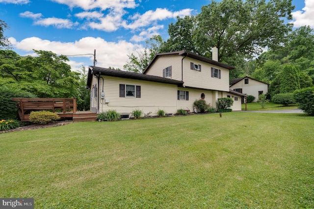 82 Quarry Rd, Birdsboro, PA 19508 - view of home's exterior featuring a chimney, a lawn, a deck, and a garage