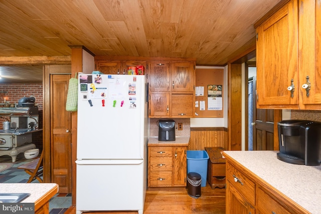 82 Quarry Rd, Birdsboro, PA 19508 - kitchen featuring freestanding refrigerator, wood ceiling, light countertops, light wood-type flooring, and brown cabinets
