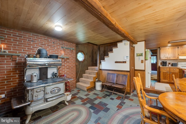 living room featuring brick wall, wood ceiling, and wood walls