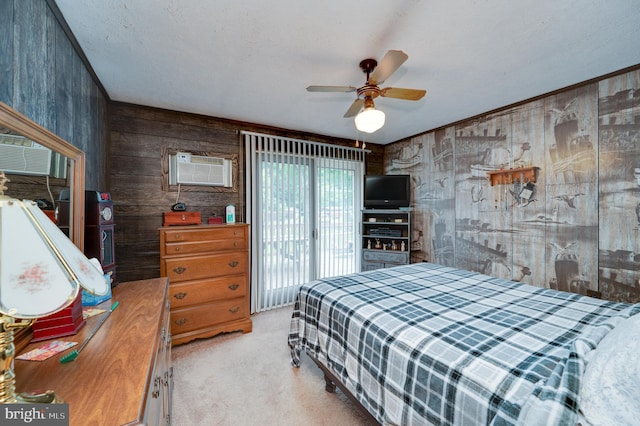 carpeted bedroom with ceiling fan, a wall mounted AC, and wood walls