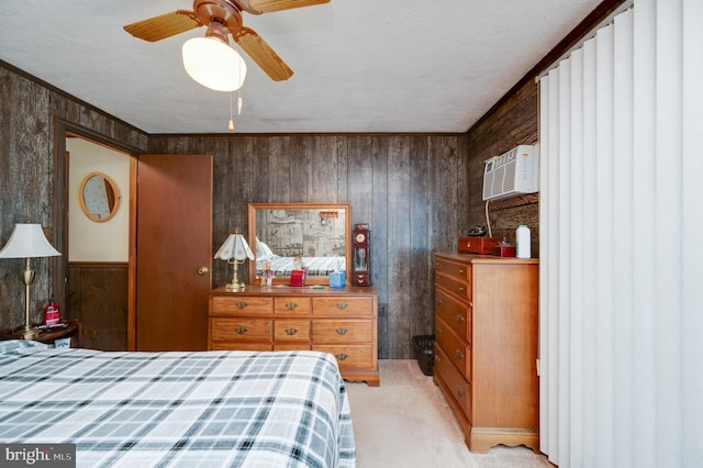 carpeted bedroom with a textured ceiling, an AC wall unit, ceiling fan, and wood walls