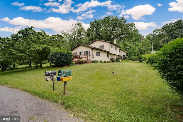 view of front of house with a front lawn and a deck