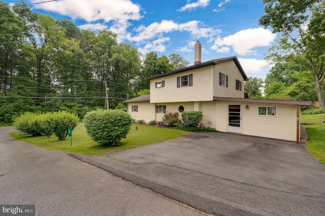 82 Quarry Rd, Birdsboro, PA 19508 - view of front facade with a front yard, a chimney, and asphalt driveway