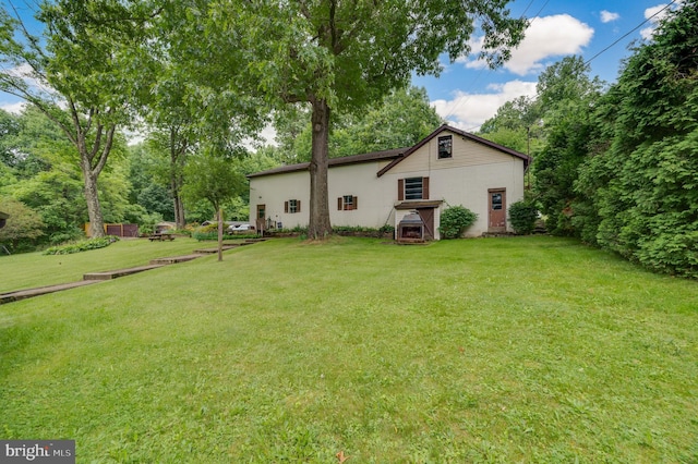 back of house with a lawn