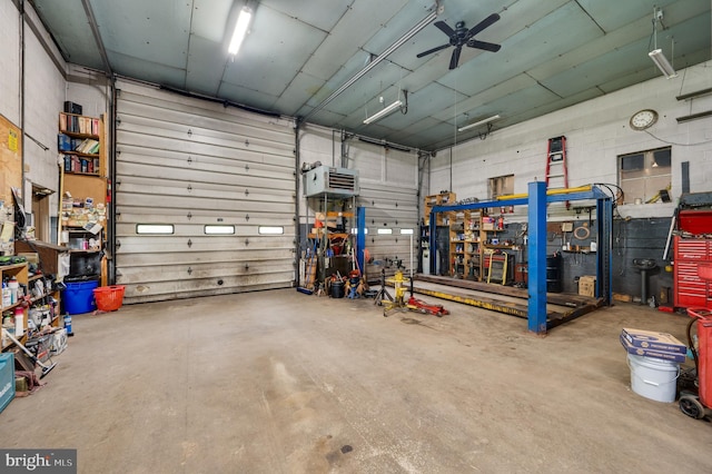 garage with a workshop area and ceiling fan