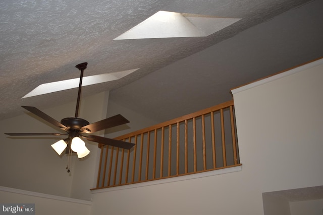 room details with a skylight, ceiling fan, and a textured ceiling