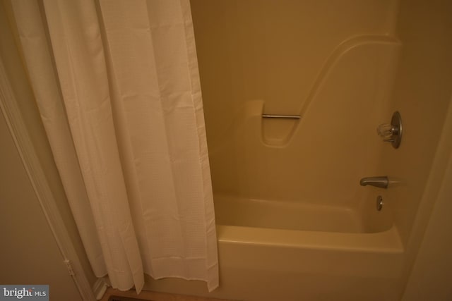 bathroom featuring shower / bathtub combination with curtain