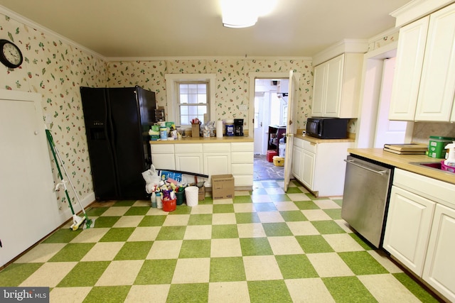 kitchen with butcher block counters, white cabinetry, crown molding, and black appliances