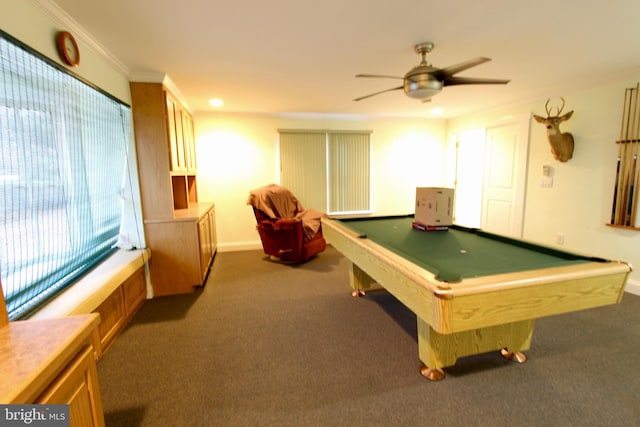 rec room with ceiling fan, dark colored carpet, ornamental molding, and billiards