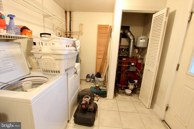 laundry room with washer and dryer and light tile patterned floors