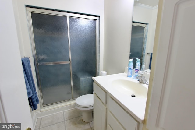 bathroom with vanity, crown molding, tile patterned flooring, toilet, and a shower with shower door