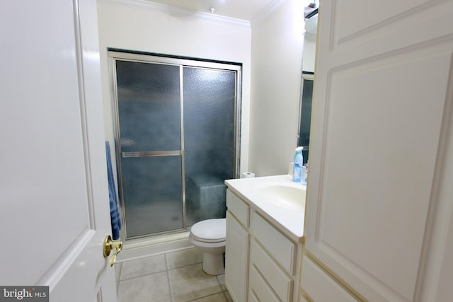 bathroom with vanity, crown molding, tile patterned flooring, toilet, and a shower with shower door