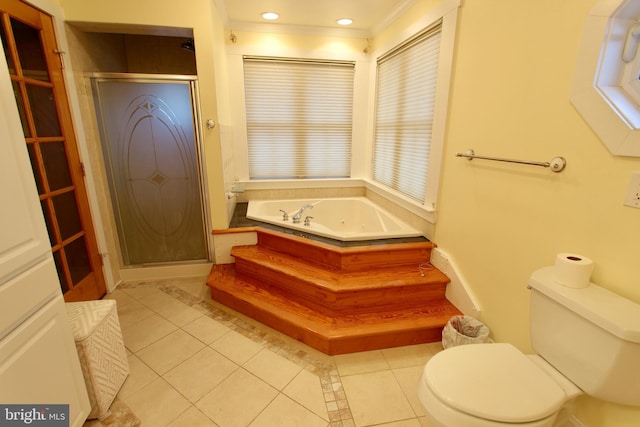 bathroom with tile patterned floors, toilet, ornamental molding, and shower with separate bathtub