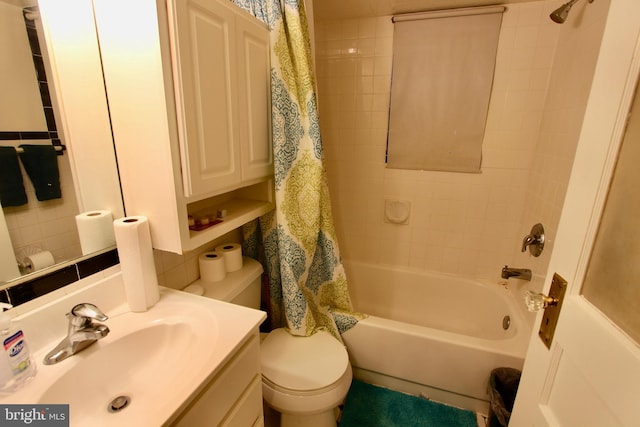 full bathroom featuring shower / bath combo, vanity, and toilet