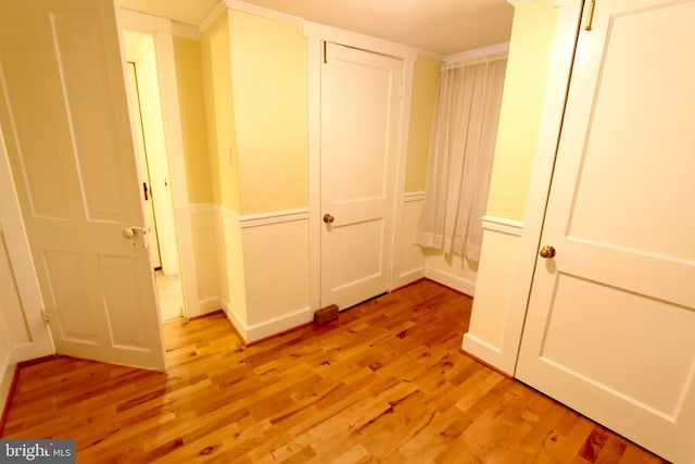 corridor with light hardwood / wood-style floors