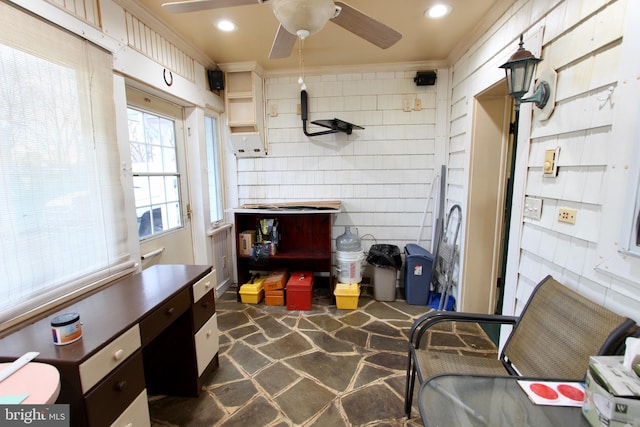 interior space with ceiling fan