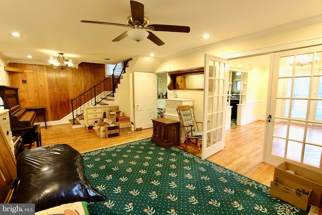 living room with french doors, plenty of natural light, ornamental molding, and hardwood / wood-style floors