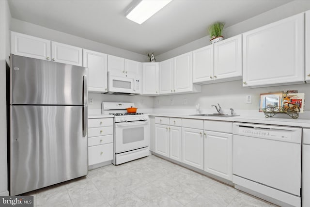 kitchen featuring white cabinetry, sink, and white appliances