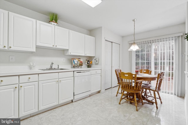 kitchen with pendant lighting, white dishwasher, white cabinetry, and sink