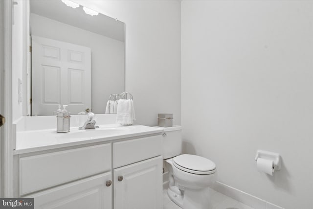 bathroom featuring tile patterned floors, vanity, and toilet