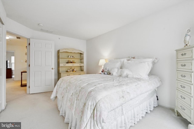 bedroom featuring light carpet