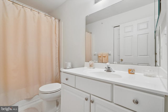 bathroom with tile patterned floors, vanity, toilet, and walk in shower