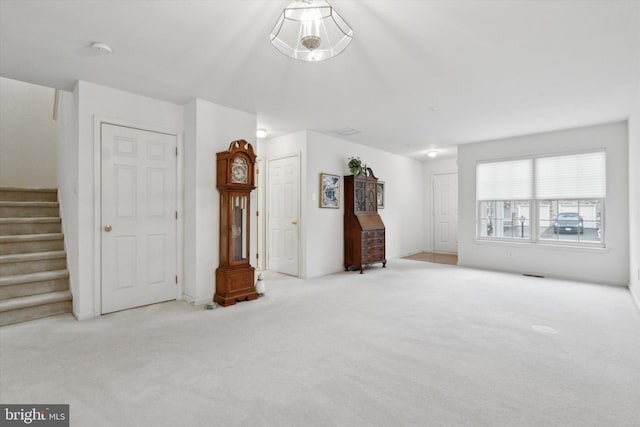 unfurnished living room featuring light carpet