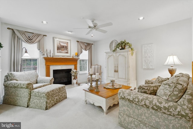 carpeted living room with a wealth of natural light and ceiling fan