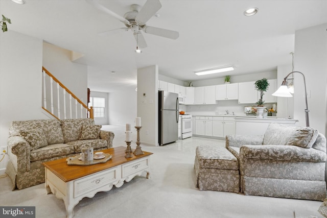 living room featuring ceiling fan and sink