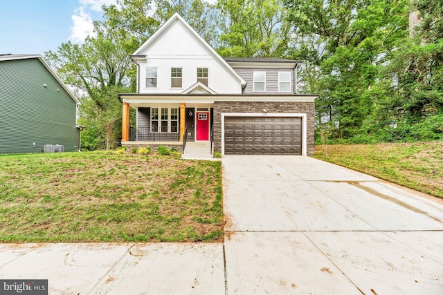 view of front of property featuring a front lawn, a porch, and a garage