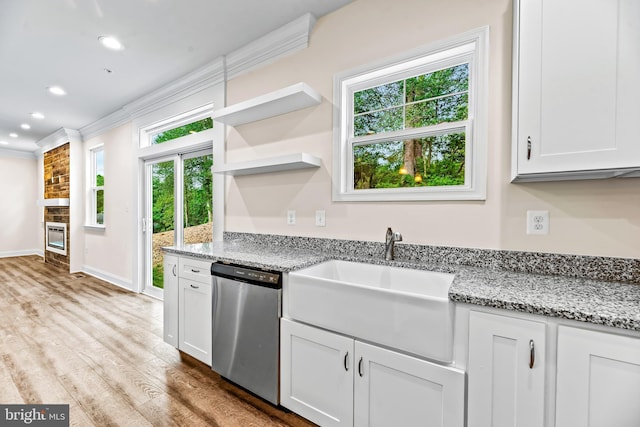 kitchen with a healthy amount of sunlight, white cabinetry, sink, and stainless steel dishwasher