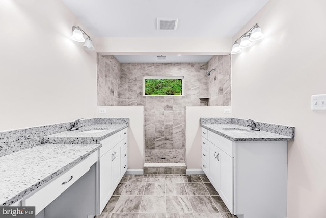 bathroom featuring vanity and tiled shower