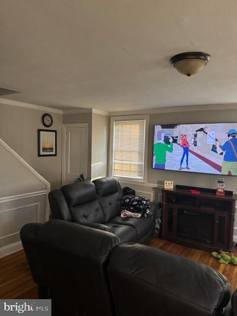 cinema featuring crown molding and dark hardwood / wood-style flooring