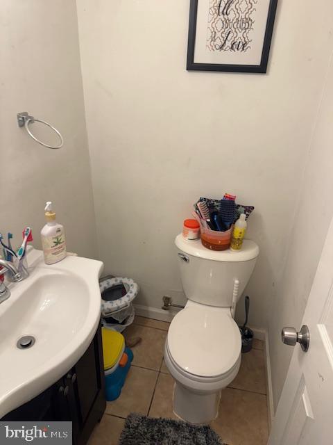 bathroom with tile patterned flooring, vanity, and toilet