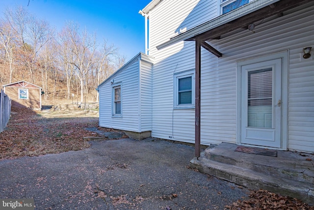 view of property exterior featuring a shed