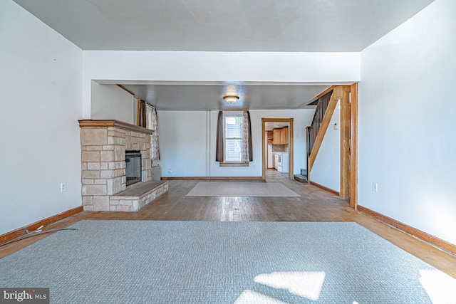 unfurnished living room with a fireplace and hardwood / wood-style flooring