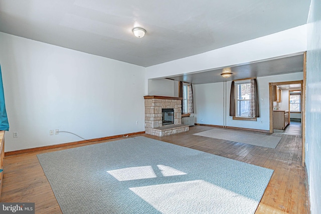 unfurnished living room with a fireplace and hardwood / wood-style floors