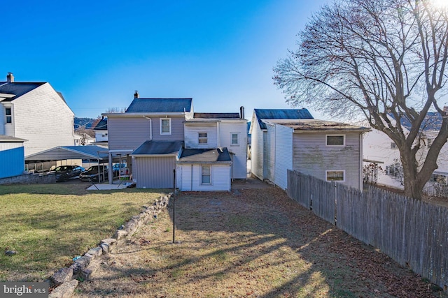 rear view of property with a yard