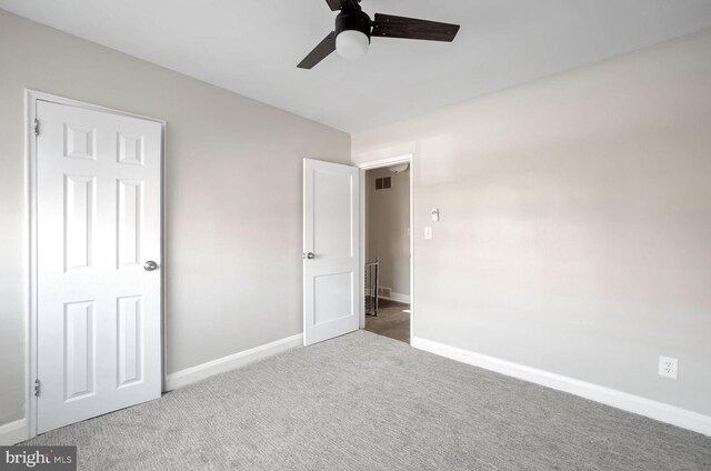 unfurnished bedroom featuring ceiling fan and carpet floors