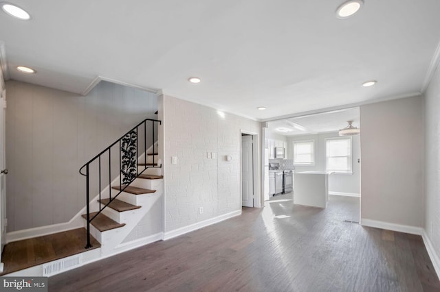 unfurnished living room featuring dark hardwood / wood-style flooring and crown molding