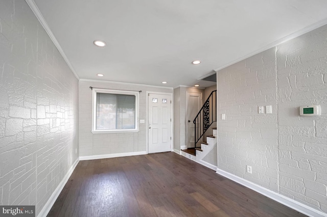 foyer entrance featuring dark hardwood / wood-style floors and crown molding