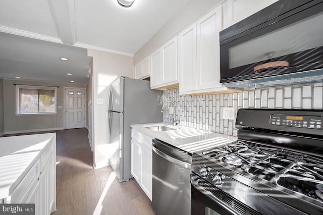 kitchen featuring sink, white cabinetry, light hardwood / wood-style flooring, and black appliances