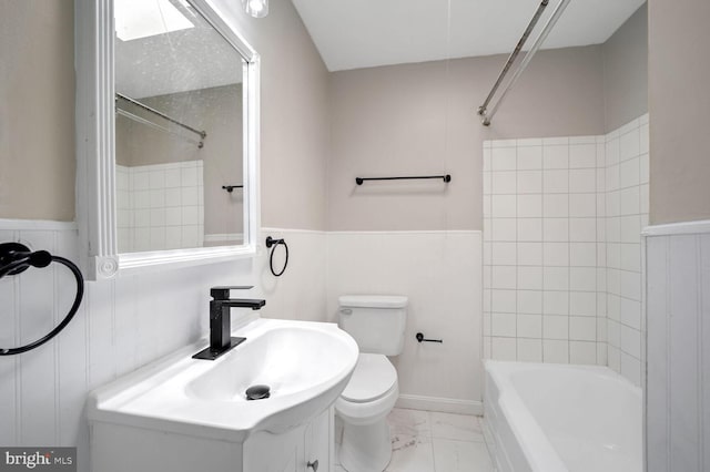 full bathroom with toilet, tiled shower / bath, and sink